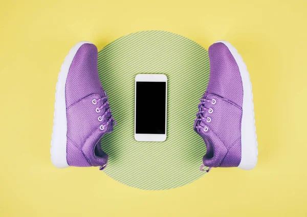 Flat lay shot of sneakers and smartphone.