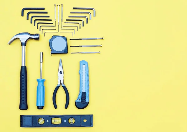 Set of tools. Home improvement concept on yellow background.