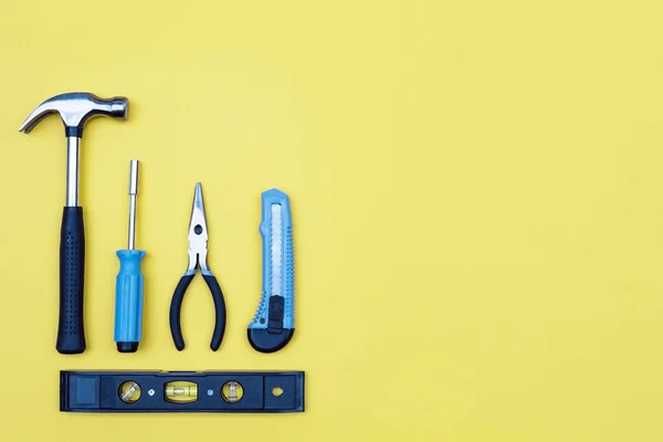 Toolbox set of tools. Home improvement concept on yellow background.