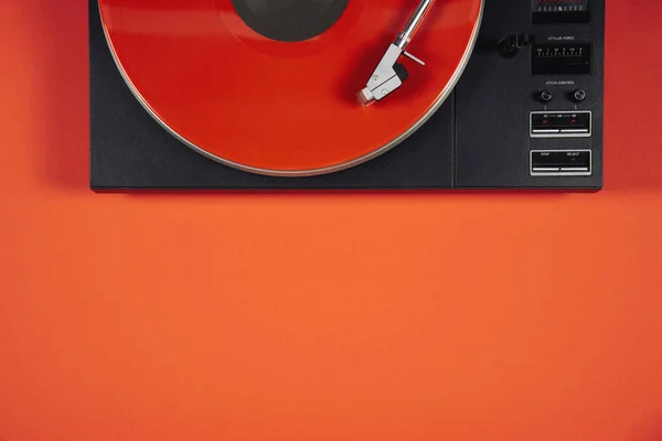 Colored vinyl record on a red background with copy space. — Stockfoto