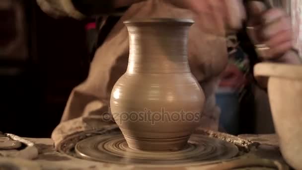 Traditional pottery making, close up of potters hands shaping a bowl on the spinning by clay — Stock Video