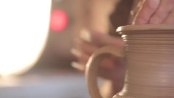 Potter making jug. Close-up of potter making ceramic jug on at his workshop — Stock Video