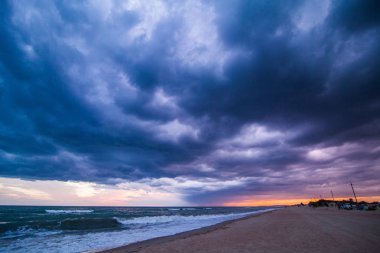 Sahilde günbatımı, fırtına