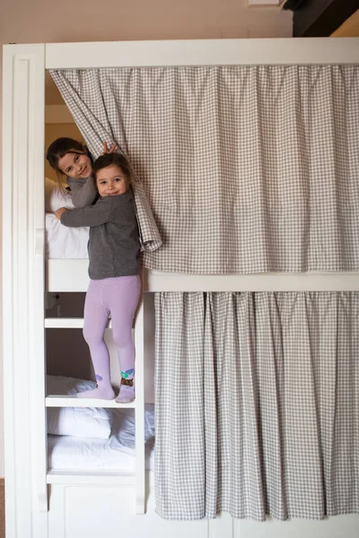 Two young girls about to go to sleep on bunk bed — Stock Photo, Image