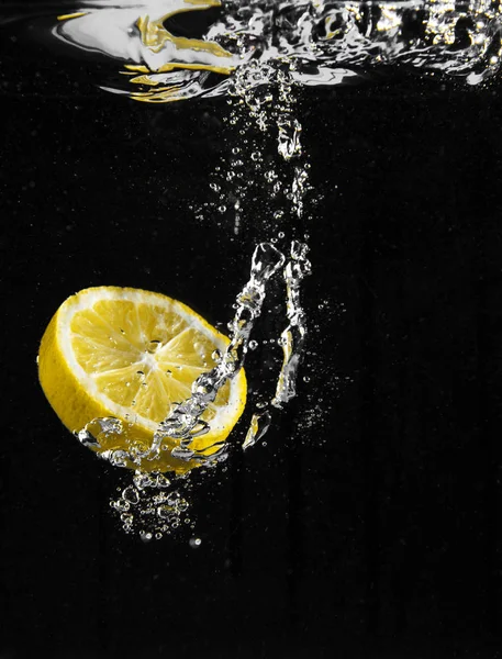fresh lemon falling in water