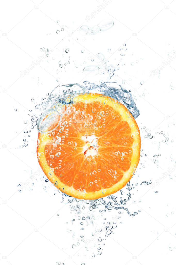 fresh orange falling in water