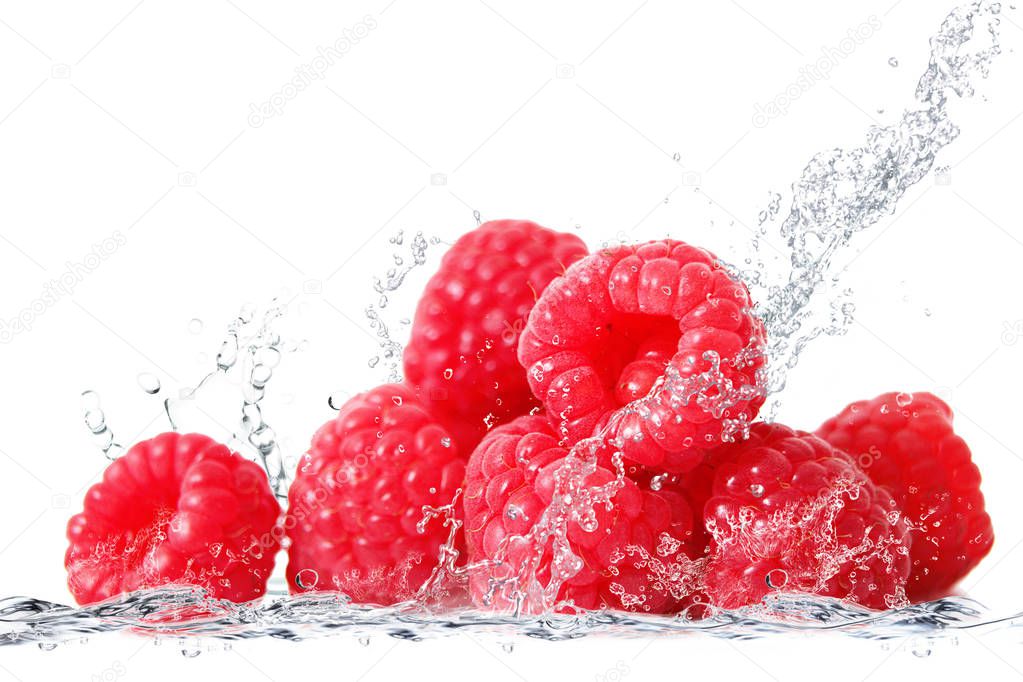 fresh raspberries falling in water