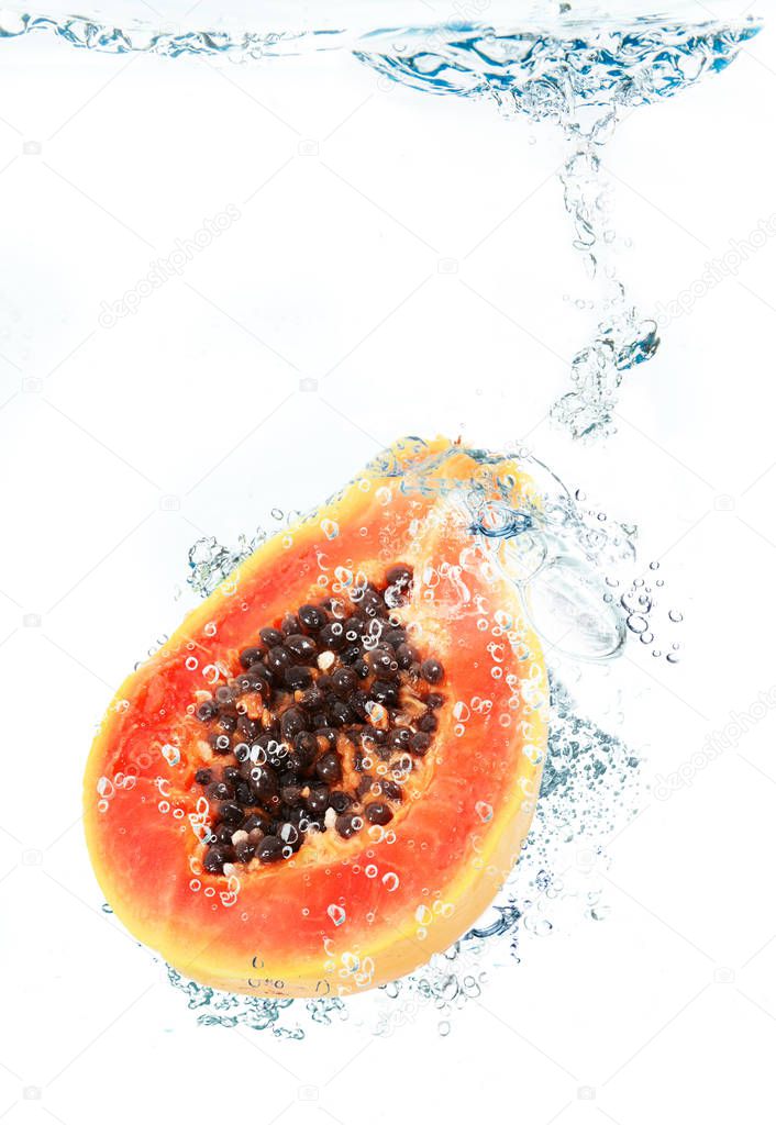 fresh papaya falling in water