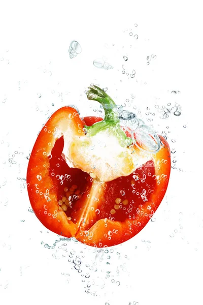 Fresh peppers falling in water — Stock Photo, Image