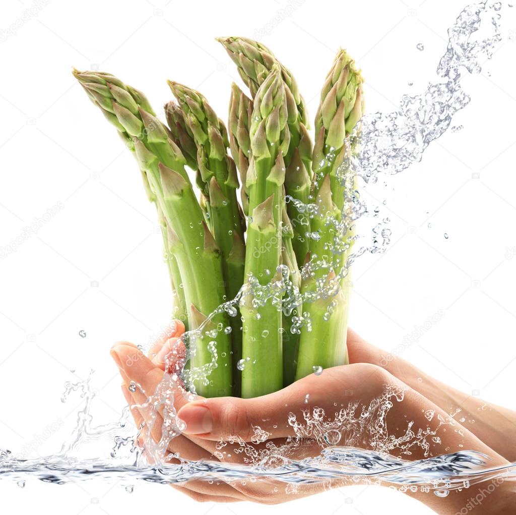 fresh asparagus falling in water