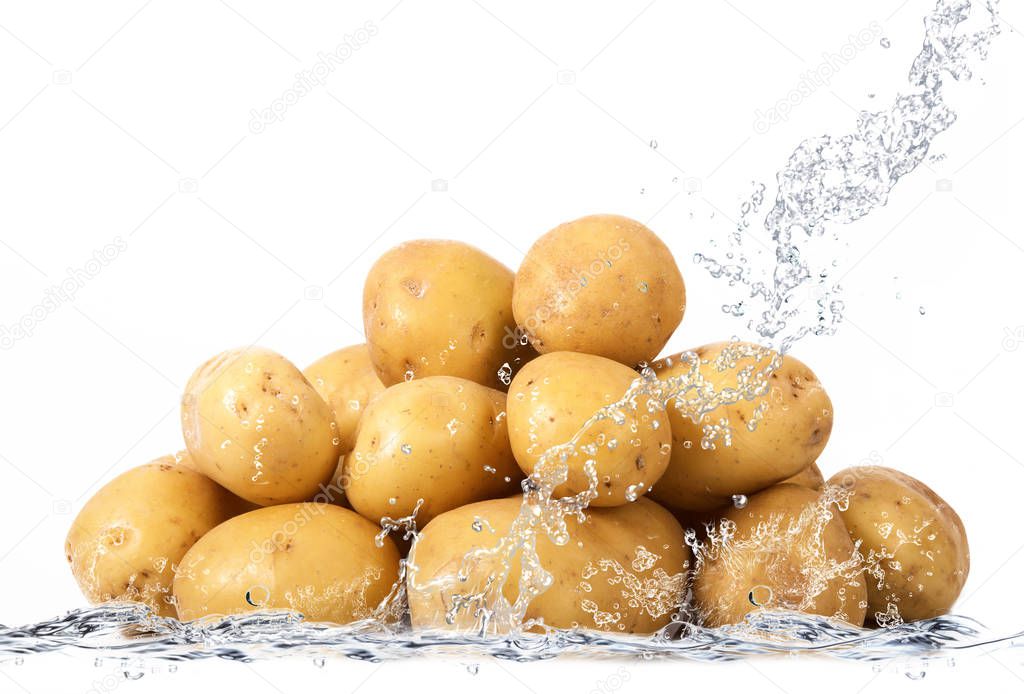 fresh potatoes falling in water
