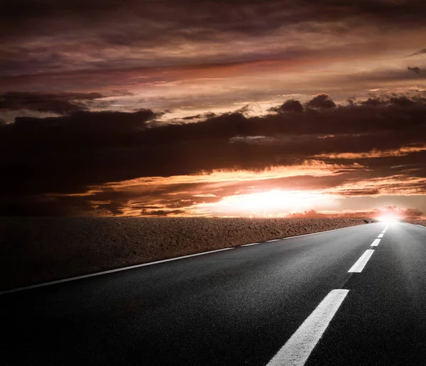 Fantastic desert road with clouds — Stock Photo, Image