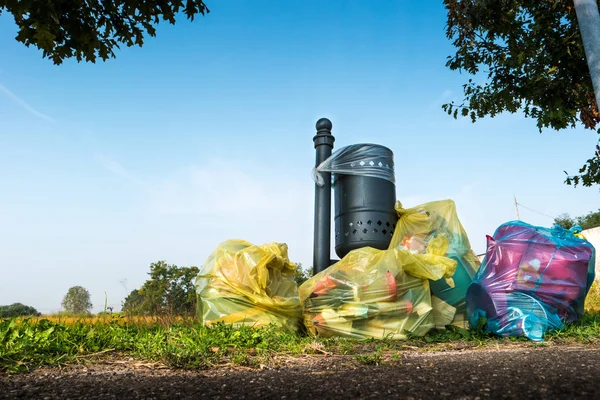 Abandoned garbage bags near lawn — Stock Photo, Image