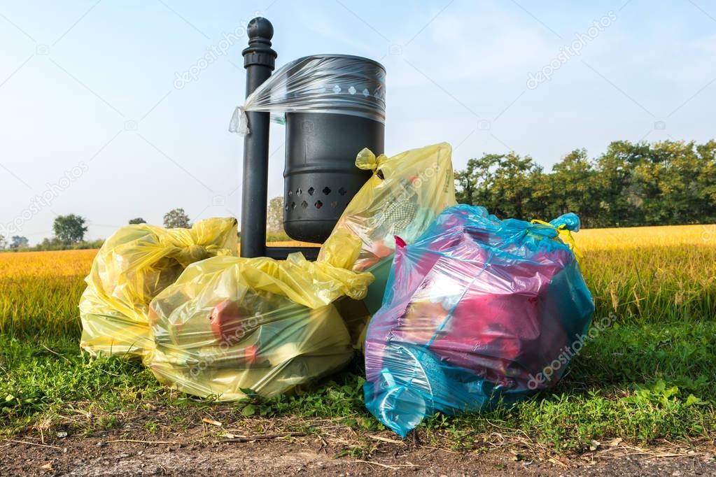 abandoned garbage bags near lawn