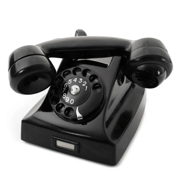 Устаревший телефон на черном фоне — стоковое фото