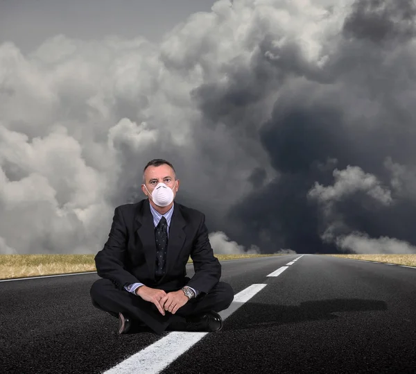 Man sitting in a middle of the road — Stock Photo, Image