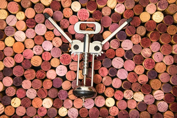 Corkscrew in corks background — Stock Photo, Image