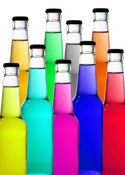 Botellas de colores en fondo blanco — Foto de Stock