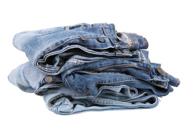 Kot pantolon beyaz arka planda yığılmış