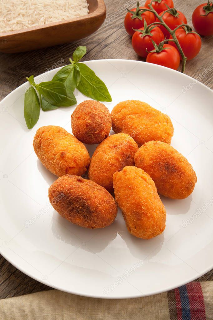 rice fried croquettes dish in wooden background
