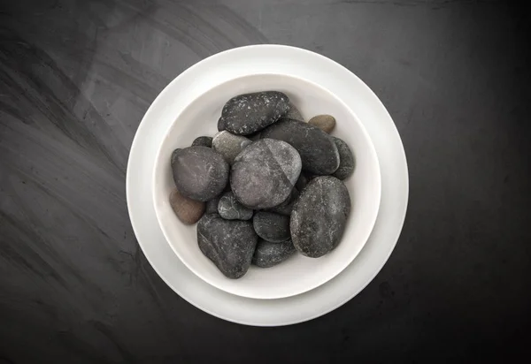 Stenar i skålen i mörk bakgrund — Stockfoto
