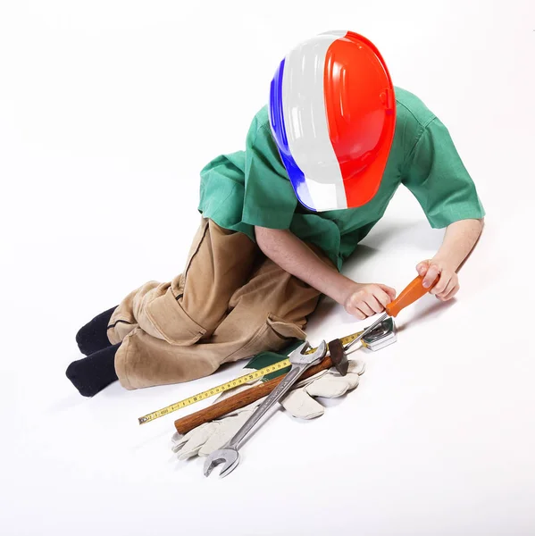 年轻的法国男孩玩工具的工作 — 图库照片