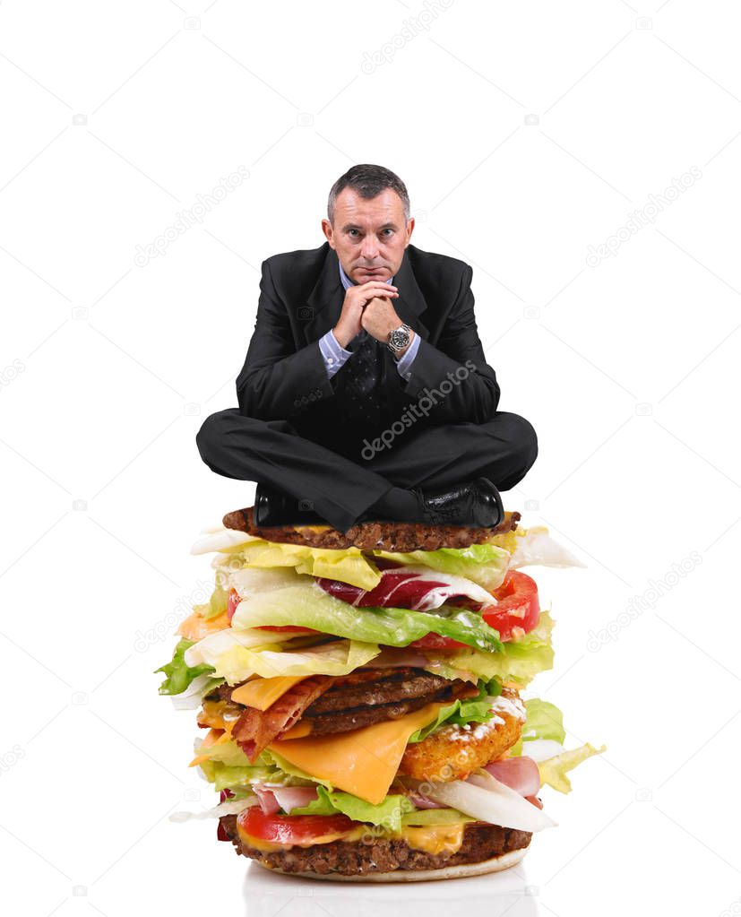 business man sitting on a big sandwich in white background