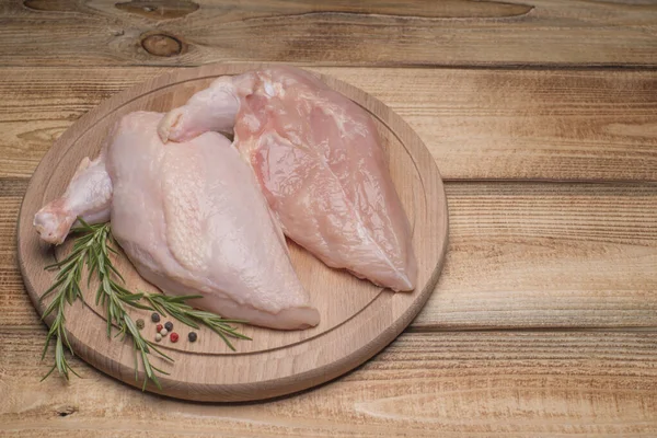 Raw chicken meat on wooden board. Fresh chicken meat. Fresh chicken fillet with a wing on a wooden cutting board.Healthy eating.Chiken supreme.