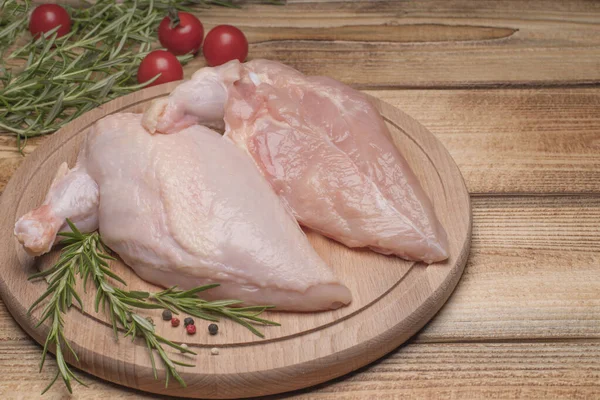 Raw chicken meat on wooden board. Fresh chicken meat. Fresh chicken fillet with a wing on a wooden cutting board.Healthy eating.Chiken supreme.