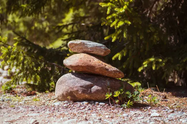 Natural stone pyramids on the river bank. Stone balance close up.Close-up abstract image of stones balanced like pyramid. Stock Photo