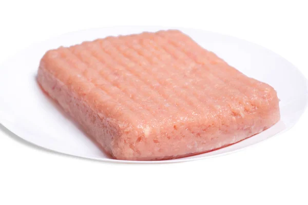 Raw chicken mince on a white plate and on a white background. Close-up of chicken mince. Delicious diet meat.Isolate. — 图库照片