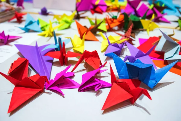 Paper cranes from multi-colored paper. Japanese origami from colored paper.Colorful Origami Paper Cranes Background