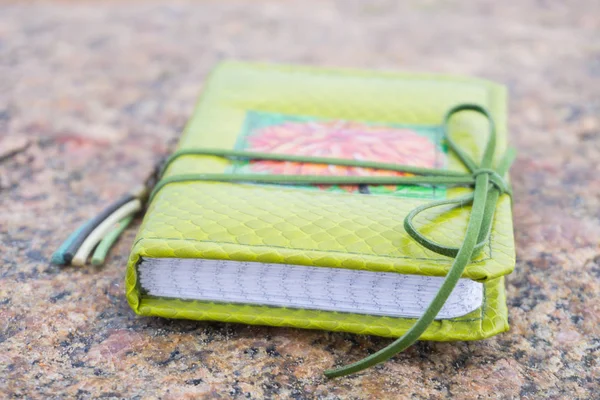 Little green handmade notebook in scrapbooking style with dark g