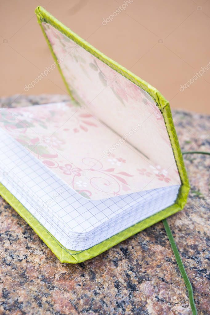 Little green handmade notebook in scrapbooking style with dark g