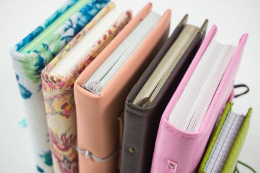 Handmade decorated notebooks and planners of different colors on clipart