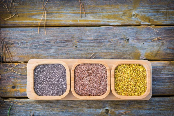 Spices in wooden bowls with autumn decorations on the wooden tab — Stock Photo, Image