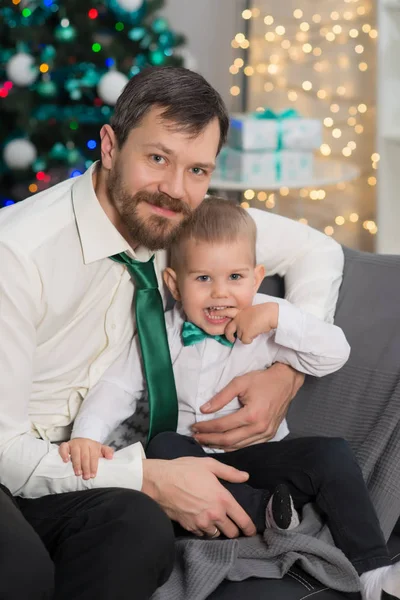 Otec se svým synem v vánoční zdobené interiéru s — Stock fotografie