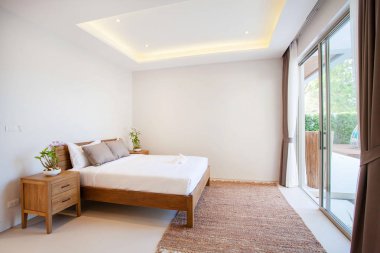 Lüks iç tasarım havuzlu villa ile rahat kral yatak odasında yatak. Yüksek yükseltilmiş tavana yatak odası 