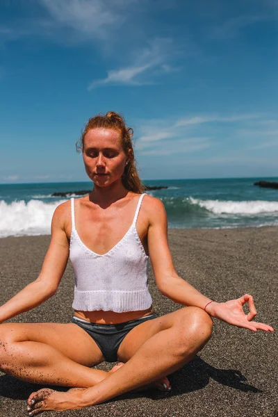 Young red hair girl practicing yoga on the beach, Indonesia, Bali — Stock Photo, Image