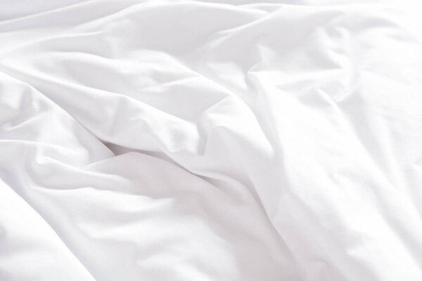 White crumpled bed sheet in a hotel room
