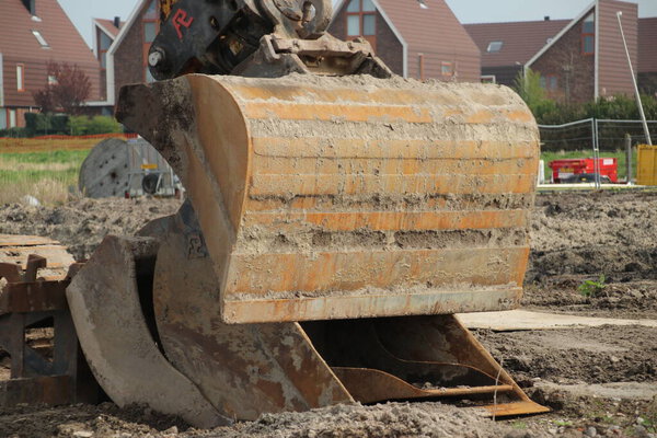 Excavator in the Eendragtspolder to build a new luxury residential area in Zevenhuizen, Netherlands