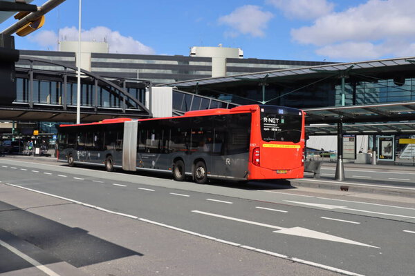 R-Net busses at the Amsterdam Schiphol Airport Plaza with a few travelers due to corona virus crisis
