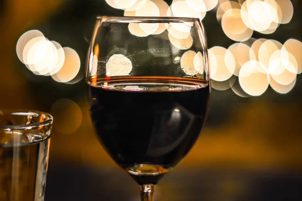 Verre de vin rouge devant l'arbre de Noël — Photo