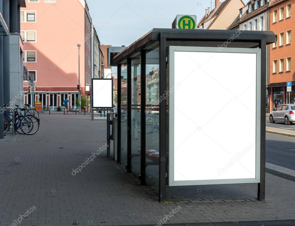 Blank ad space sign isolated at a bus stop in the street