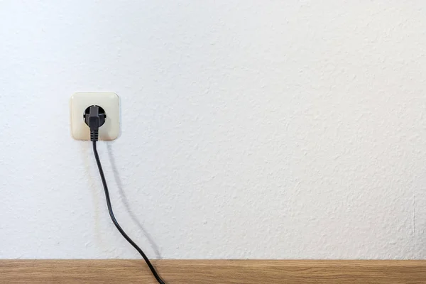 One single european plug on a white wall