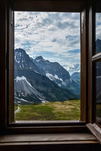 Looking through a wooden window frame to see the mountains of th — Stock Photo, Image