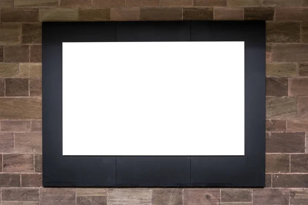 Blank ad space screen on stone wall