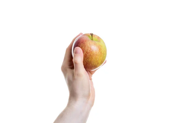 Segurando uma maçã na mão no fundo branco — Fotografia de Stock