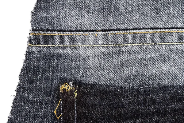Piece of black jeans fabric with ripped of back pocket — 스톡 사진