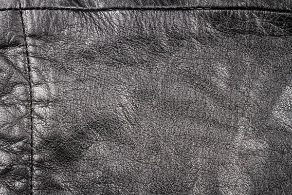 皱褶的黑色皮革纹理背景 皮革的抽象纹理与接缝 — 图库照片